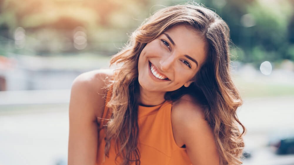 Woman Smiling Touching Chin